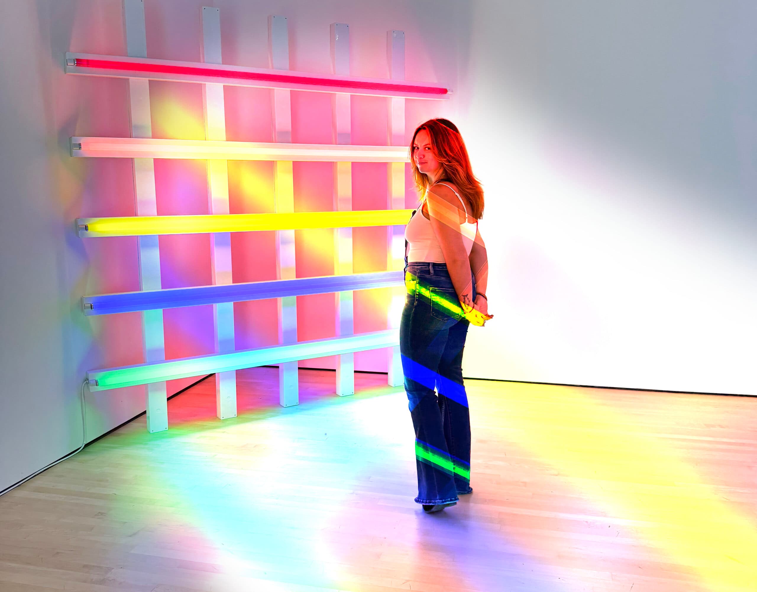 Londynn in a rainbow neon-light installation.