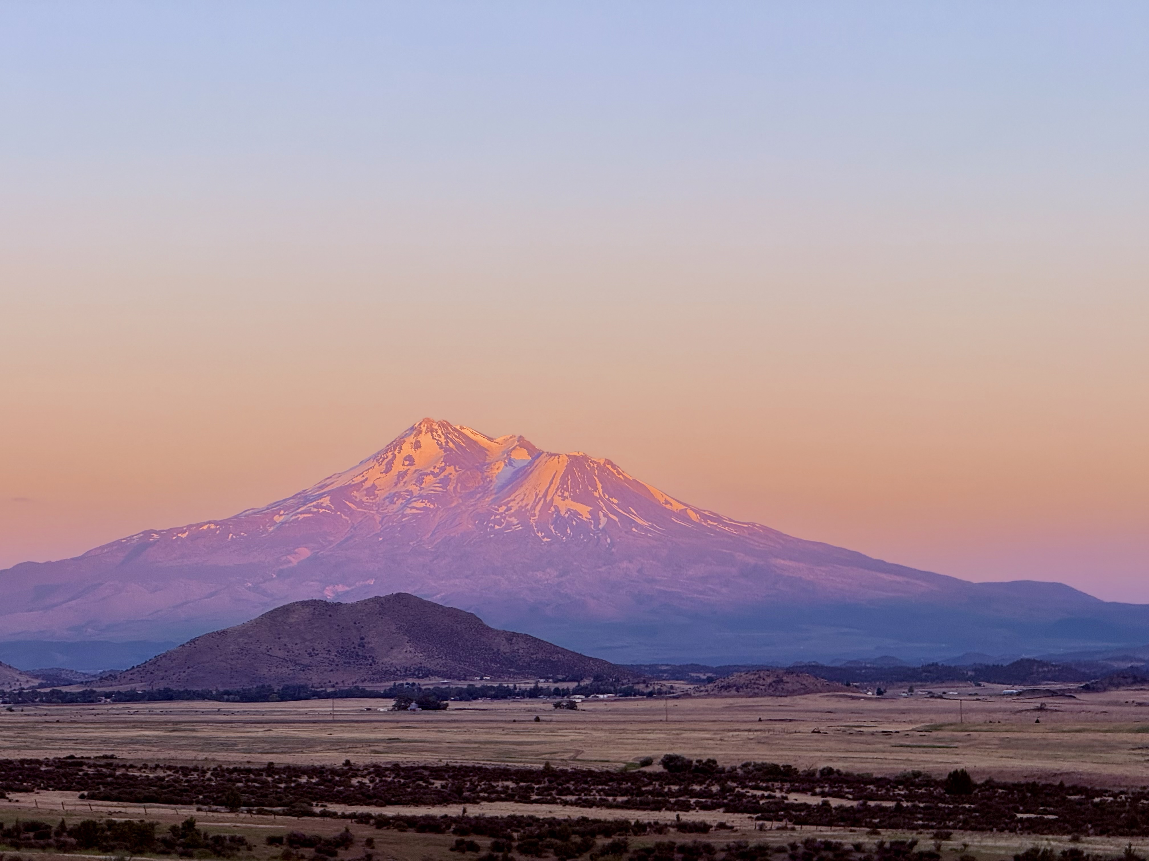 Mount Shasta at sunset — the 14,179-foot stratovolcano above town